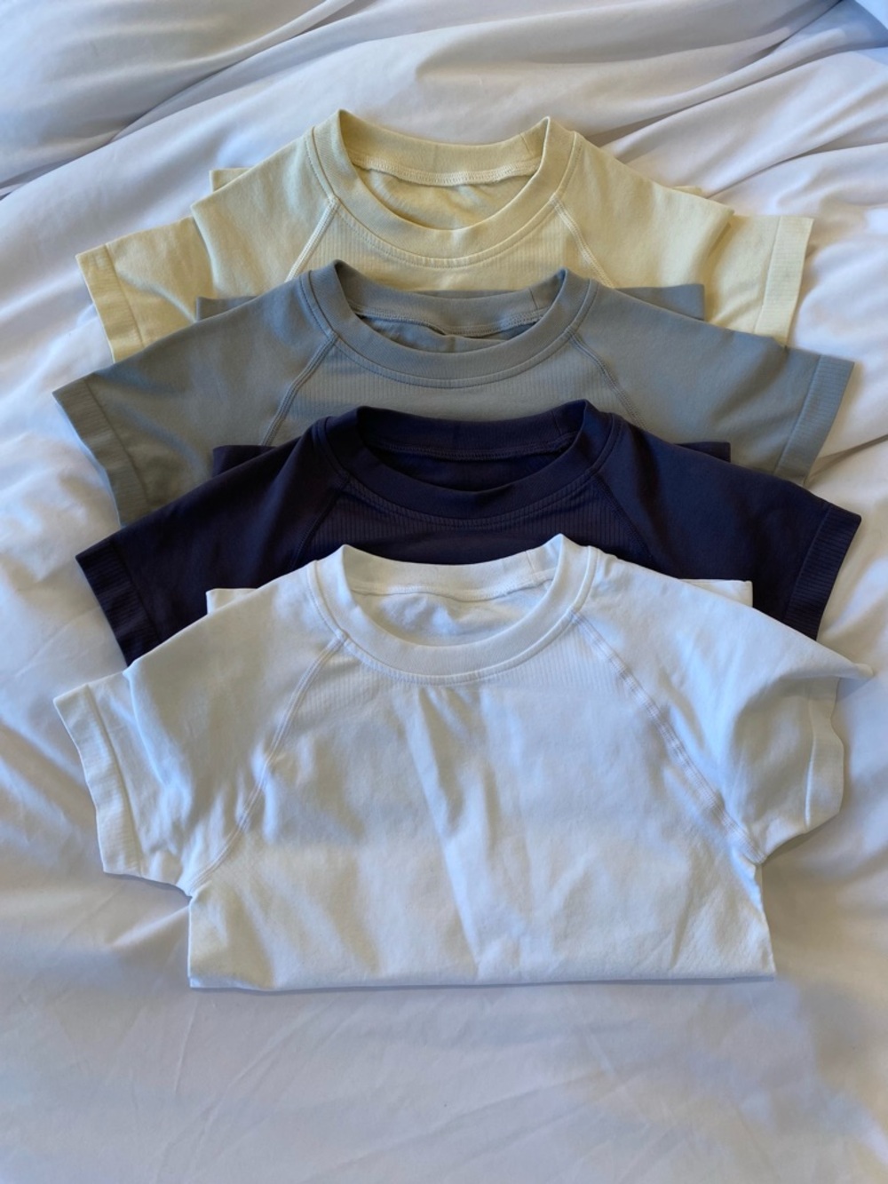 4 pack workout tops/shirts- never worn. Size small. Stretchy